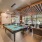 Clubhouse game area with billiards table, lounge seating, and modern lighting at Hermann Park Lofts.