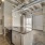 Modern kitchen with stainless steel appliances, granite island, and open layout at Hermann Park Lofts.