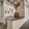 Apartment kitchen with granite breakfast bar, wood cabinetry, and stainless steel appliances at Hermann Park Lofts.