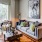 Open space fully furnished living area with couch, art on walls and natural lighting from window sliding doors onto the private balcony