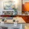 Kitchen with granite countertops, wood cabinetry, breakfast bar seating, and modern appliances at Hermann Park Lofts.