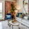 Living room with sofa, bold artwork, and large window overlooking the city at Hermann Park Lofts.